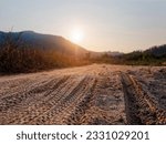 Car tyre track on sand Off road drive Mountain Landscape blur background