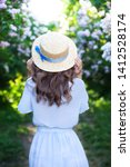 Girl In A Straw Hat With Blue...
