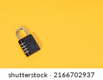 Number Padlock isolated on yellow background. Copy space. Top view