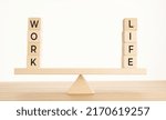 Small photo of Balance Between Life And Work concept. Wooden blocks with word on Seesaw. Copy space