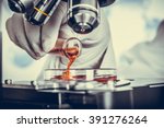 Serious clinician studying chemical element in laboratory Vintage