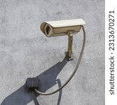 Small photo of CCTV camera on a concrete wall. Protection of the object with the help of a video surveillance camera, CCTV close-up.