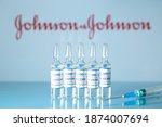 Small photo of New York, USA - 14 December 2020. Concept of vaccine against COVID-19. Glass medical vials with liquid. Ampoules with coronavirus vaccine on a medical glass table. Selective focus