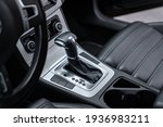 black leather car interior close up.Design details of minimalist concept of modern car - close-up details of automatic transmission and gear stick. car interior - devices, driving concept