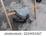 Small photo of Sandbag used to weigh down a frame displaying a temporary road sign