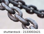 Old rusty anchor chain. Iron chain links defocused diagonally. Simple background.