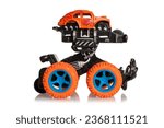 Small photo of Kids toy Bigfoot with big orange wheels isolated on white