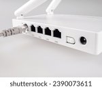 Small photo of internet cable close-up on the background of a Wi-Fi router, close-up, cable and wireless internet, lan cable, Gigabit Ethernet