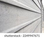 Close up modern prefab concrete fence Constructed from prefabricated concrete panels stacked together isolated on white background