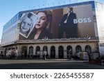 Small photo of Paris, France - February 21, 2023: 'Be your own Boss' giant advertising billboard for Hugo Boss covering the scaffoldings of the restoration work on the facade of a parisian building