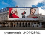 Small photo of Paris, France - January 5, 2024: Large advertising billboard for the new Rouge Dior lipstick from Dior covering the scaffoldings of the restoration work on the facade of a parisian building