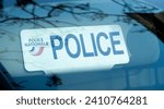 Small photo of Paris, France - January 5, 2024: Close-up of the sun visor plate of an unmarked police vehicle with the word "POLICE" and the logo of the French national police