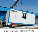 Small photo of The Crane trucks transport the mobile office buildings or container site office for installation in the construction site area, project mobilization.