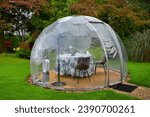 Heated transparent dome or pod for outdoor dining, table set for 2 persons