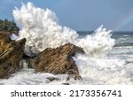 Sea waves break on coastal...