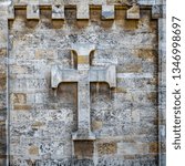 Small photo of Varna, Bulgaria, is March, 13, 2019 : background, texture. Cross on the lithoidal wall of cathedral.