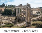 Small photo of Rome, Lazio, Italy - 09 04 2023: View of the Temple of Vespasian and Titus and the Temple of Saturn in the Forum Romanum