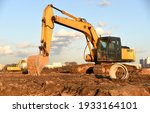 Small photo of Excavator dig the trenches at a construction site. Trench for laying external sewer pipes. Sewage drainage system for a multi-story building. Digging the pit foundation.