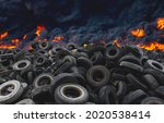 Small photo of Tyres are on fire. Burning old tyres on recycling landfill. Black smoke from tires fire. Tyre graveyard at rubber burning plant. Wheel tire recyclers, tyre for reuse. Pile of old wheels in blaze.