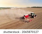 Agricultural tractor sowing...