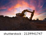 Small photo of Excavator on earthmoving on sunset background. Loader at open pit mining. Excavator digs gravel in quarry. Heavy construction equipment on excavation. Earth mover ar construction site. Open-pit mine.