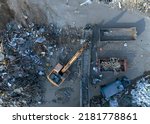 Small photo of Landfill with Construction waste (CDW). Trash disposal for recycling and re-use. Excavator log grab crane on landfill. Recycling of Construction waste or debris. Secondary raw. Wood Waste Recycling.
