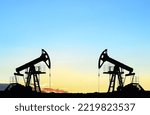 Small photo of Crude oil Pumpjack on sunset. Fossil crude output and fuels oil production. Oil drill rig and drilling derrick. Global crude oil Prices, energy, petroleum demand (OPEC+). Pump jack at oilfield.