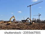 Small photo of Excavator dig ground at construction site. Dig foundation. Construction of residential buildings and renovation. Earthmover on groundwork. Excavator on earthmoving. Loader on dredging and trenching.