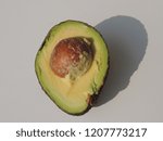 Small photo of Closeup of an avocado cut in two.