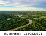 Aerial view over a tropical forest with a river in the amazon rainforest
