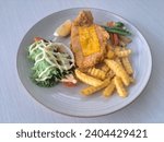Small photo of Fish And Chips - Deep Fried Red Snapper Fillet In Crispy Batter, Served With Tar Tar Sauce. French Fries Or And Mixed Salad. Food Menu.