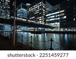 Small photo of London - 01 26 2022: View of South Dock with Heron Quays Bridge and DLR stop