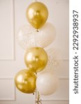 Small photo of Composition of helium balloons white,, transparent with confetti, as well and a large figure of one golden colors. Gift for 1 years