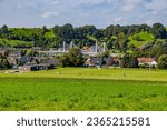 Small photo of Caestert plateau with green esplanade, suspension bridge, Kanne village and hill with green leaf trees in background, Belgian agricultural land with sown land, sunny day in Riemst, Belgium