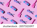 Small photo of Kid toy guitar, cassette deck player and violin on trendy pastel pink background. Top view, flat lay layout. Minimal music and party concept.