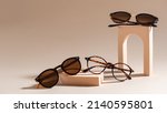 Small photo of Trendy sunglasses of different design and eyeglasses on a beige background. Copy space. Sunglasses and spectacles sale concept. Optic shop promotion banner. Eyewear fashion. Minimalism