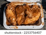 Small photo of Delicious Smothered Chicken in a White Takeout Container