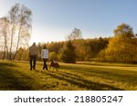 Couple walk retriever dog autumn sunset countryside meadow holding hands