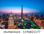 WOW view of Dubai skyline at night. City lights popping. Blue sky. Iconic landmarks. Luxury travel holiday concept.