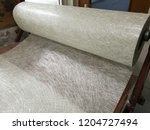 stock-photo-fiberglass-chop-strand-mat-roll-on-the-table-is-in-process-for-prepare-raw-material-in-frp-1204727494.jpg