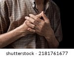 Small photo of Asian elder man suffering from central chest pain. Chest pain can be caused by heart attack, myocardial infarct or ischemia, myocarditis, pneumonia, oesophagitis, stress, etc,.