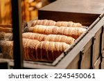 Trdelnik (Trdelník) or trdlo on a showcase shop, Kind of spit cake it is made from rolled dough that is wrapped around a stick then grilled and topped with sugar and walnut mix, Prague, Czech Republic
