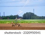 Small photo of Irrigation carts, Irrigation trolley, Irrigation system for irrigating crops Waters the freshly sown field. Irrigation equipment on the freshly sown field.