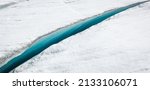 Small photo of Long, gorgeous icy-blue crack or crevasse in glacier