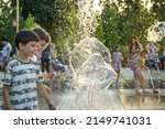 Small photo of Boys jumping in water fountains. Children playing with a city fountain on hot summer day. Happy friends having fun in fountain. Summer weather. Friendship, lifestyle and vacation.