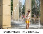 Small photo of Boy having fun in water fountains. Child playing with a city fountain on hot summer day. Happy kids having fun in fountain. Summer weather. Active leisure, lifestyle and vacation.