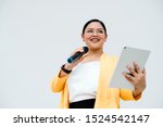 Small photo of Fat girl wearing glasses reading scrip from tablet.