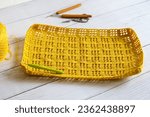 Small photo of Summer crochet big bag.Crochet market bag with wood crochet needle on white background. Handmade and craft. Summer big bag women, new trendy simple casual, large crochet shoulder bag.