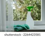 Cleaning agent, wipes and rubber gloves on the windowsill. General cleaning concept