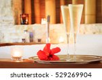 Two glasses of champagne with candle and red flower near jacuzzi. Valentines background. Romance concept. Horizontal